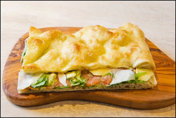 Roman stuffed focaccia sandwich with cold cuts, cheese and various vegetables