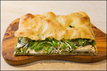 Roman stuffed focaccia sandwich with cold cuts, cheese and various vegetables