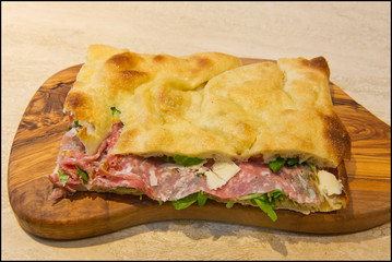 Roman stuffed focaccia sandwich with cold cuts, cheese and various vegetables
