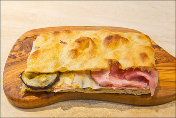Roman stuffed focaccia sandwich with cold cuts, cheese and various vegetables