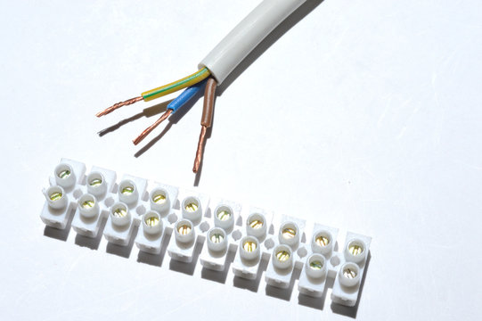 stripped wire and terminal block on a white background.