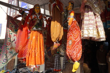 Souvenir Hand made colorful Rajasthan puppets displayed for sale outside a shop. Traditional Indian...