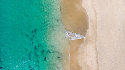 Top View on Coast of Atlantic Ocean, waves on beach aerial view, crystal clear water in Morro Jable Fuerteventura. 