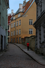 a man climbing the narrow street of an ancient city