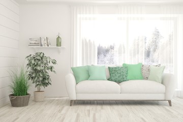Modern living room in white color with sofa and winter landscape in window. Scandinavian interior design. 3D illustration