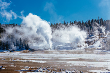 Colorful Porcelain Basin area trail with steaming vents and fumaroles in Yellowstone National Park, Wyoming, USA