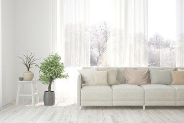 Fototapeta premium Modern living room in white color with sofa and winter landscape in window. Scandinavian interior design. 3D illustration