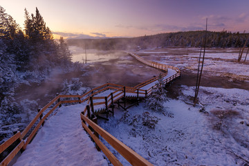 Fototapeta premium Colorful Norris Geyser Basin area trail during colorful sunset in Yellowstone National Park, Wyoming, USA