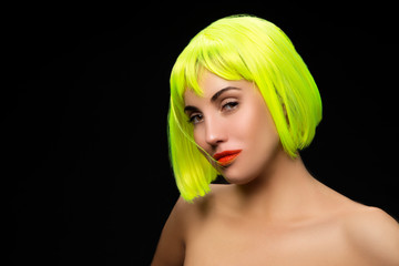 beauty portrait of young woman wearing color wig, red lips makeup, clean skin. Black backgound. Copy space