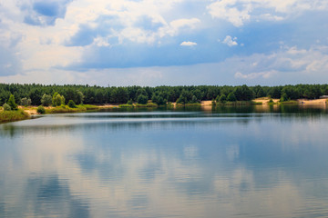Obraz premium View of a beautiful lake in a pine forest at summer