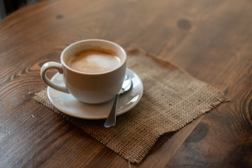 cup of coffee on wooden table