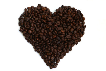 Isolated coffee beans in the shape of a heart on a white background denoting a love or passion for coffee