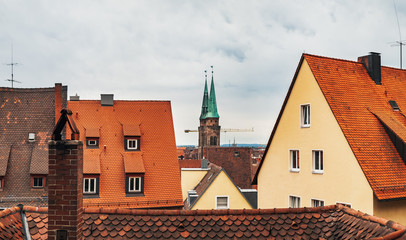 Obraz premium Old town architecture in German city of Nuremberg Nurnberg, Mittelfranken region, Bavaria, Germany. Terracotta and red medieval house roofs, cityscape top view from castle hill