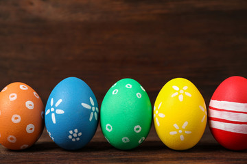 Colorful Easter eggs on wooden background. Space for text
