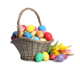 Fototapeta na wymiar Basket with colorful Easter eggs and tulips isolated on white