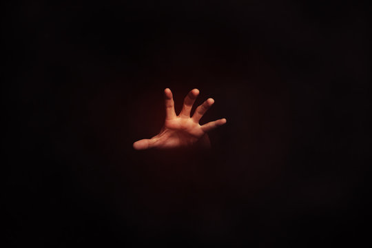 human hand palm in the dark background, conceptual idea images