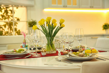 Festive Easter table setting with floral decor in kitchen