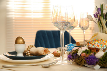 Festive Easter table setting with decorated eggs in kitchen