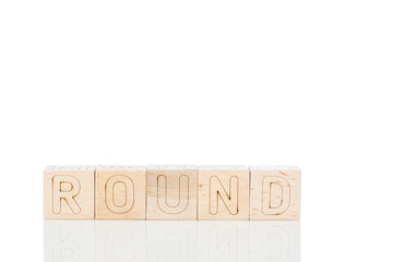 Wooden cubes with word round on a white background