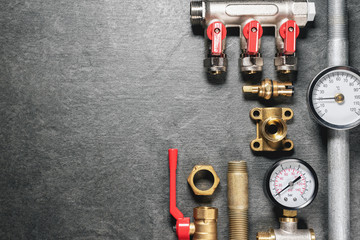Plumbing equipment on gray flat lay background with copy space.