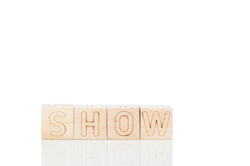 Wooden cubes with word show on a white background