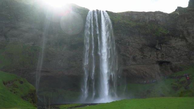 Gljufrabui, Iceland - May 2019: Gljufrabui waterfall with tourists walking, Iceland