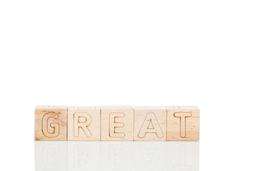 Wooden cubes with word great on a white background