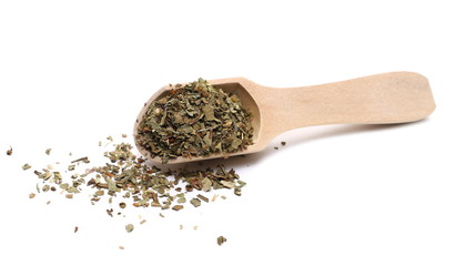 Basil dried spice in wooden spoon isolated on white background