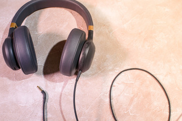 Colored headphones on a colored background. Music concept with copyspace. Colored headphones isolated.