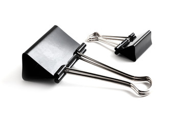 Black paper clips for paper documents clamping. Office metal foldback braces. Stainless steel foldback clips. Stationery metal binder clips isolated on white background.