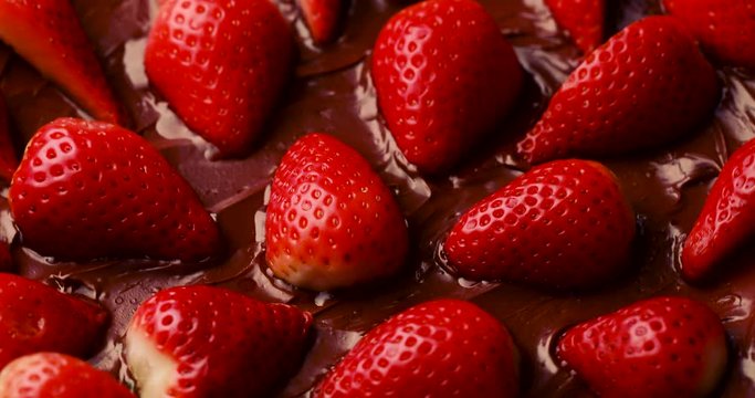 rotating delicious strawberries in chocolate, summer dessert concept