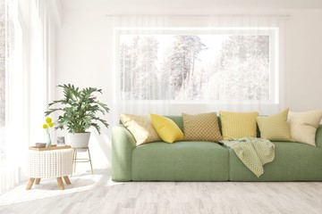 Naklejka premium Modern living room in white color with sofa and winter landscape in window. Scandinavian interior design. 3D illustration
