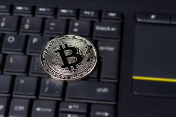 Black keyword and metal souvenir bitcoin. The concept of electronic money, online trading, mining...