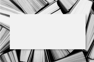 A black and white image of hardback books or textbooks with blank space