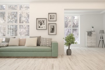 Modern living room in white color with sofa and winter landscape in window. Scandinavian interior design. 3D illustration