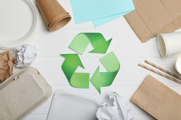 Different paper trash and garbage recycling sign on a colored background top view. The concept of...