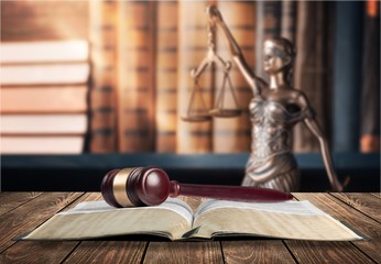 Statue of justice on library background.