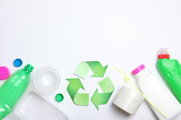 Different plastic trash and garbage recycling sign on a colored background top view. The concept of saving the planet, the separation of garbage.