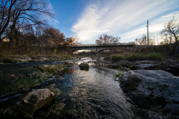 Fototapeta na wymiar river flowing under bridge