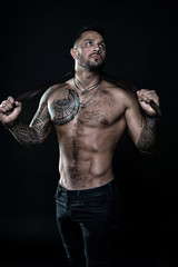 Fototapeta na wymiar fitness model topless. healthcare lifestyle. body strong abs. Wild masculine beauty. macho. brutal and sexy. muscular bodybuilder with body tattoo. athletic male hold strong belt. full of power
