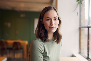 Portrait of Beautyful young woman is sitting on a café