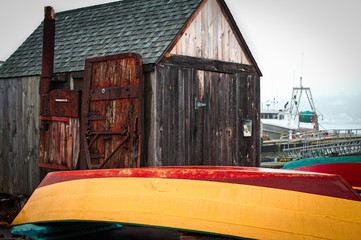 Colorful wood skiff boat rests on dock