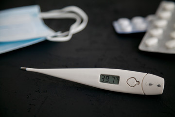 Thermometer 39.7, medicines and protective masks