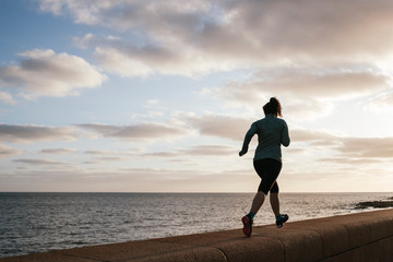 girl exercising near the sea