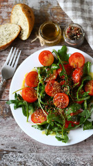 Healthy salad with arugula, cherry tomatoes and seeds. Diet concept.