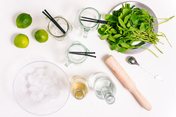 Ingredients for making mojito. Alcoholic refreshing summer drink. Mint, glass goblets, rum, syrup...