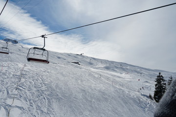 Fototapeta na wymiar Empty chair lifts in ski resort Switzerland closing up because of corona virus and lock down.