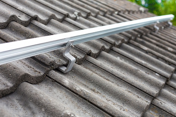 Close up of mounting rail for photovoltaic system on roof building site