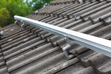 Close up of mounting rail for photovoltaic system on roof building site