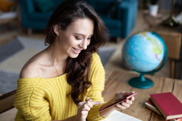 Naklejka premium Beautiful woman uses a smartphone.